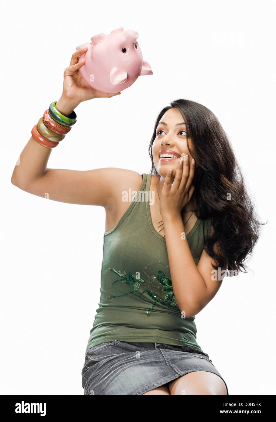 Junge Frau hob ein Sparschwein Stockfoto