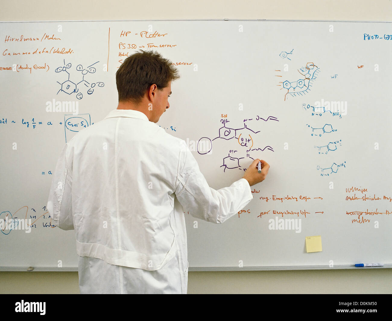 Ein Wissenschaftler auf eine weiße Tafel schreiben molekulare Diagrammen über Arzneimittelforschung. Stockfoto