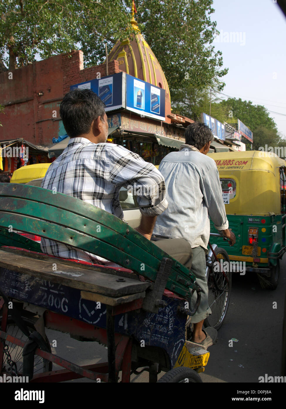 Fahrradrikscha Fähren indischen Geschäftsmann in Delhi durch starken Verkehr Stockfoto