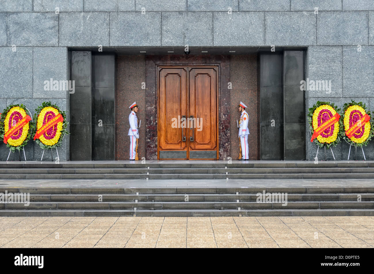 HANOI, Vietnam – zwei Wachen in voller Uniform stehen am Eingang zum Ho Chin Minh Mausoleum. Das Ho-Chi-Minh-Mausoleum ist ein großes Denkmal in der Innenstadt von Hanoi, umgeben vom Ba Dinh-Platz. Es beherbergt den einbalsamierten Körper des ehemaligen vietnamesischen Führers und Gründungspräsidenten Ho Chi Minh. Stockfoto