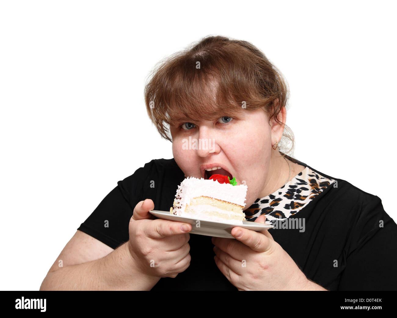 übergewichtige Frau Kuchen beißen Stockfoto