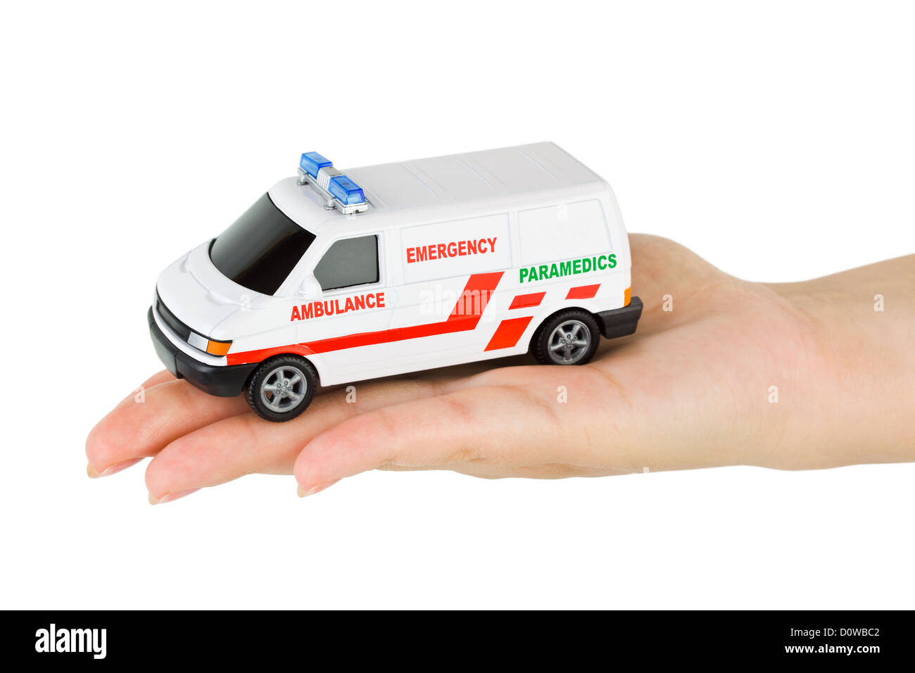 Hand mit Krankenwagen Spielzeugauto Stockfoto