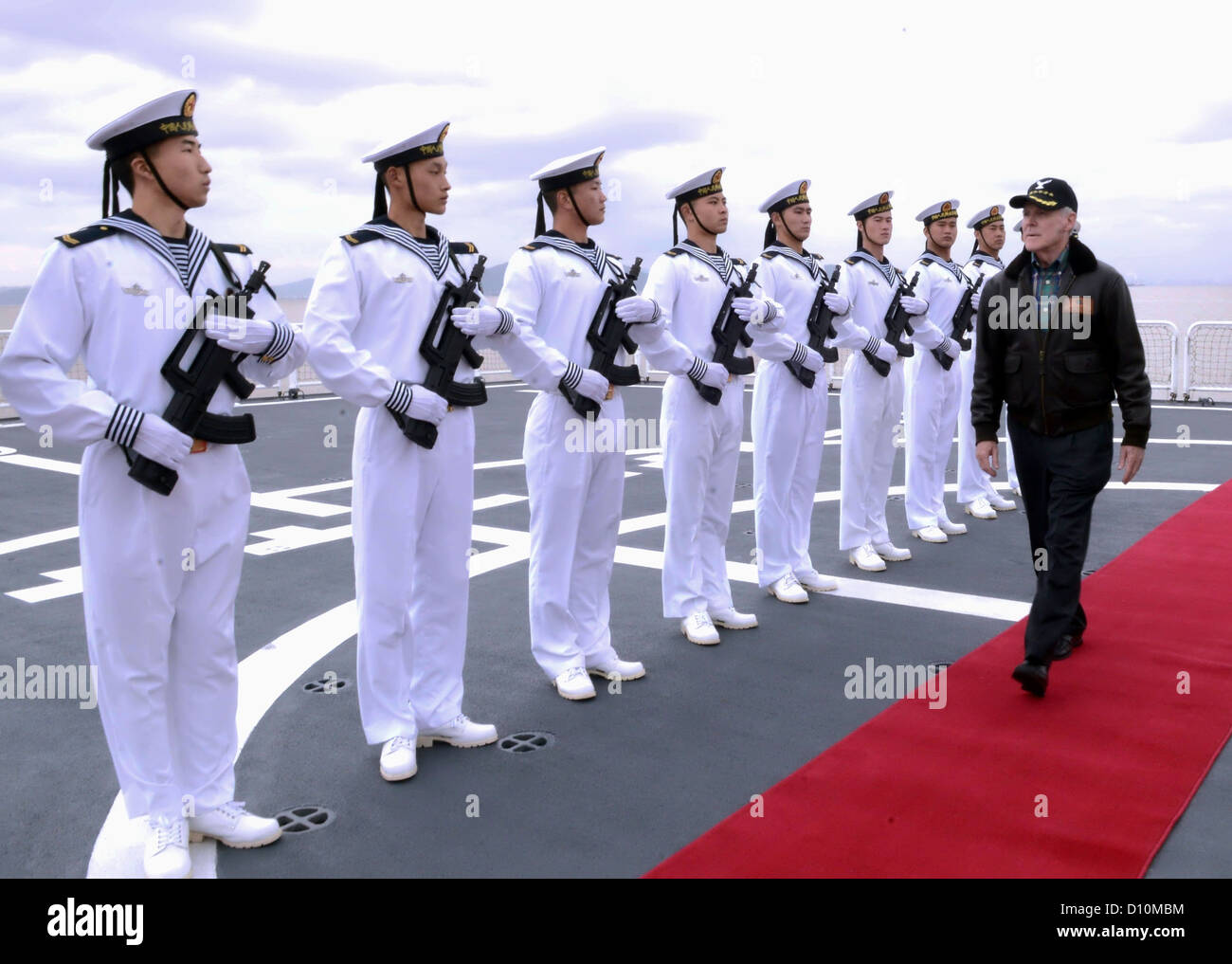 Secretary Of The Navy, Honorable Ray Mabus gerendert wird, honoriert durch chinesische Seeleute bei einem Besuch in der chinesischen Volksrepublik Liberation Army Navy Jiangkai II-Klasse Schiff Xu Zhou (FFG-539). Mabus besucht China um die neue US-Verteidigungsstrategie besprechen Dee Stockfoto