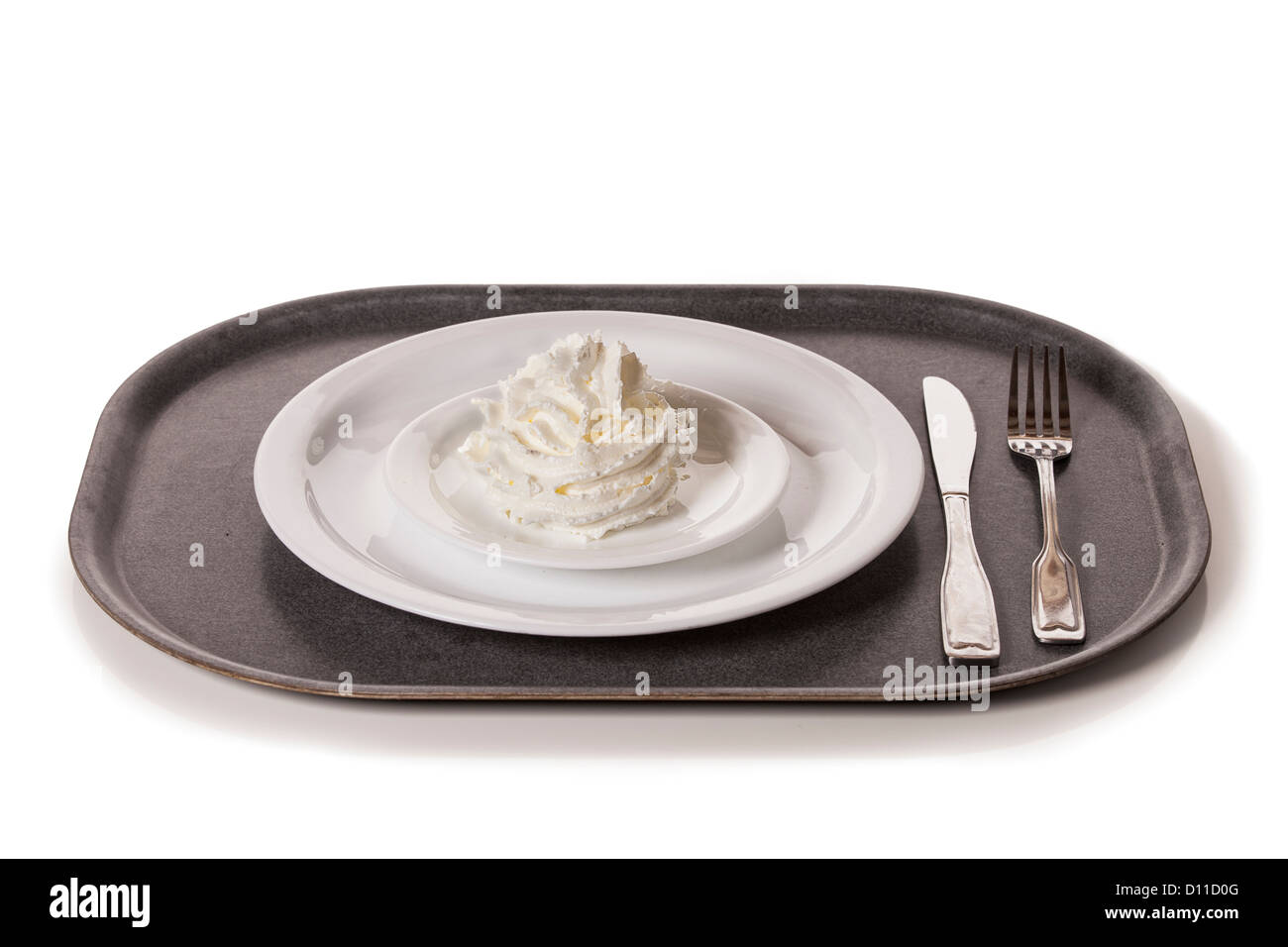 Schlagsahne auf einem Teller, bereit zu einem ungesunden Essen. Stockfoto