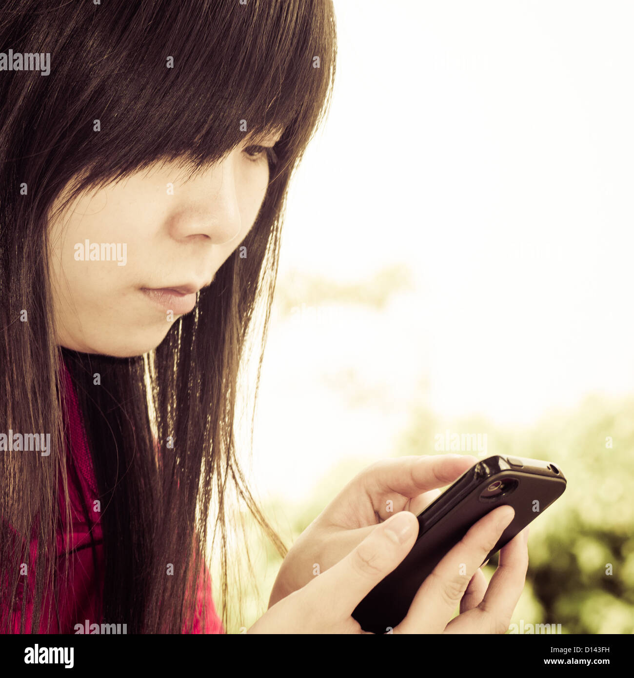 Asiatische Frau auf Handy Stockfoto