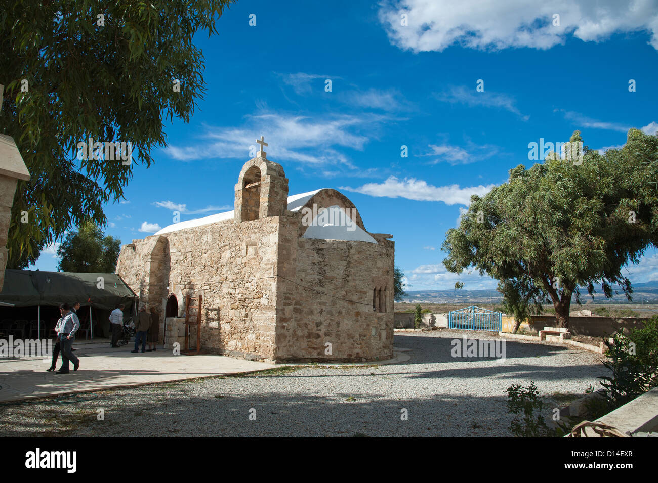 Gemeindemitglieder verlassen eine kleine Kapelle Zypern die Agios Georgios Kapelle aus lokalem Stein befindet sich in der Nähe von Lemesos Stockfoto