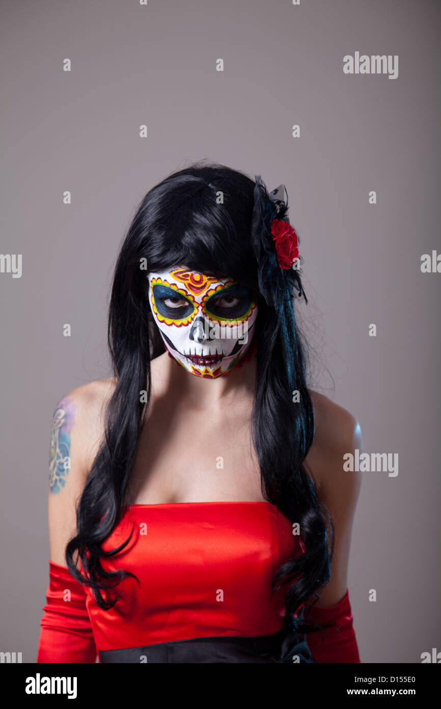 Junge Frau mit dem Zucker Schädel Halloween Make-up tragen rote Kleid, der Tag der Toten Stockfoto