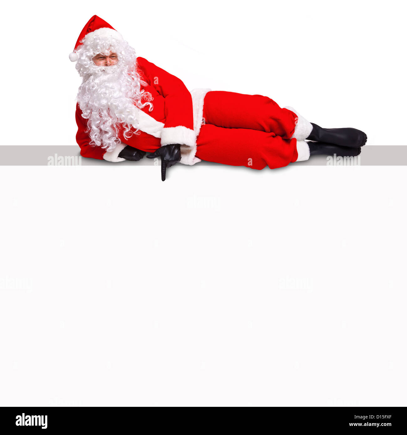 Santa Claus liegen oben auf einem leeren Plakatwand Wegweiser auf eine leere weiße Fläche, wo Sie Ihren eigenen Text hinzufügen können. Stockfoto