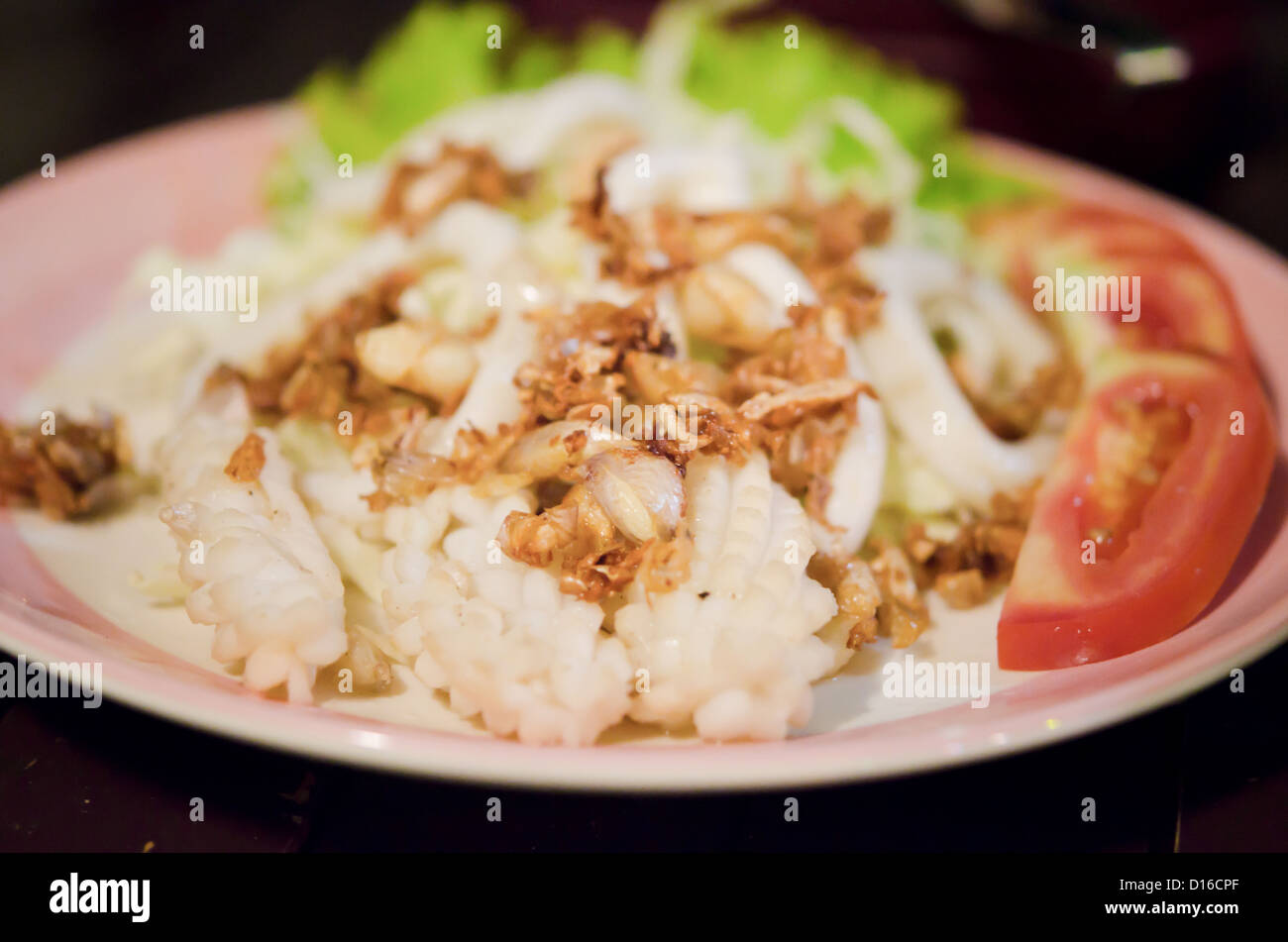 tief gebratener Tintenfisch mit gebratenem Knoblauch und frischem Gemüse Stockfoto