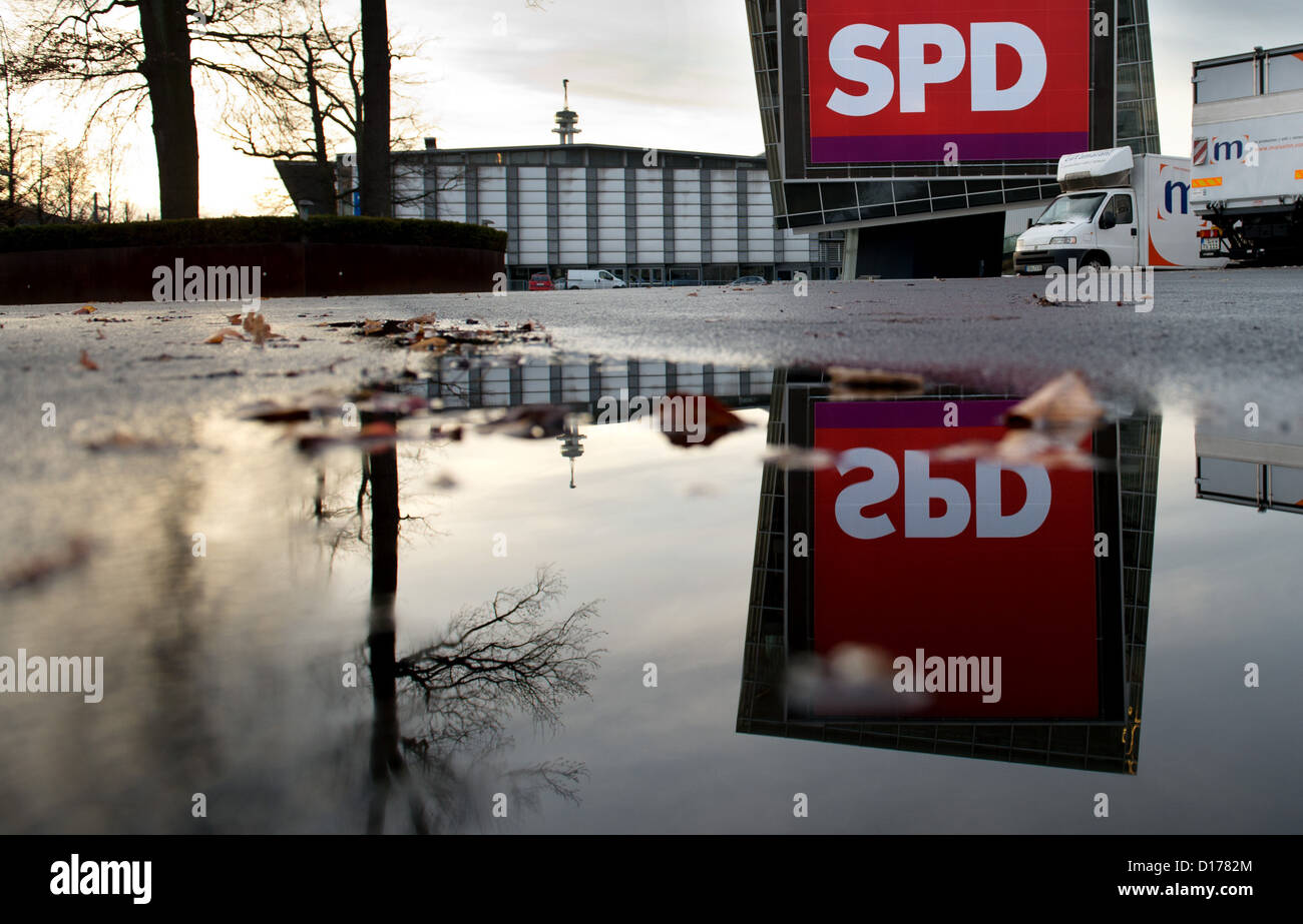Ein riesiges Banner mit dem SPD-Logo spiegelt sich in einer Pfütze vor der SPD Nationalpartei Konferenz auf dem Messegelände in Hannover, Deutschland, 7. Dezember 2012. Die außerordentlichen Parteitag der SPD wird am 9. Dezember 2012 stattfinden. Foto: JULIAN STRATENSCHULTE Stockfoto