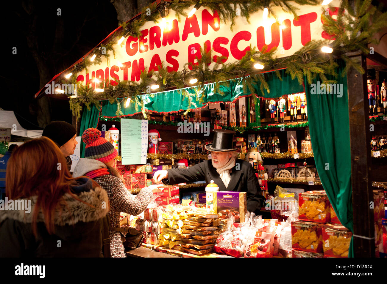 Der jährliche Weihnachtsmarkt in Lincoln, England, UK. Ein Deutsch-Keks-Verkäufer auf seinem Stall. Stockfoto