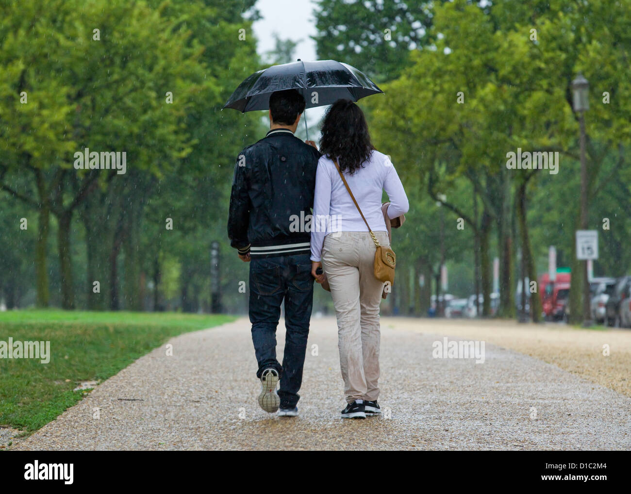 Paar teilen sich einen Regenschirm im Regen - USA Stockfoto
