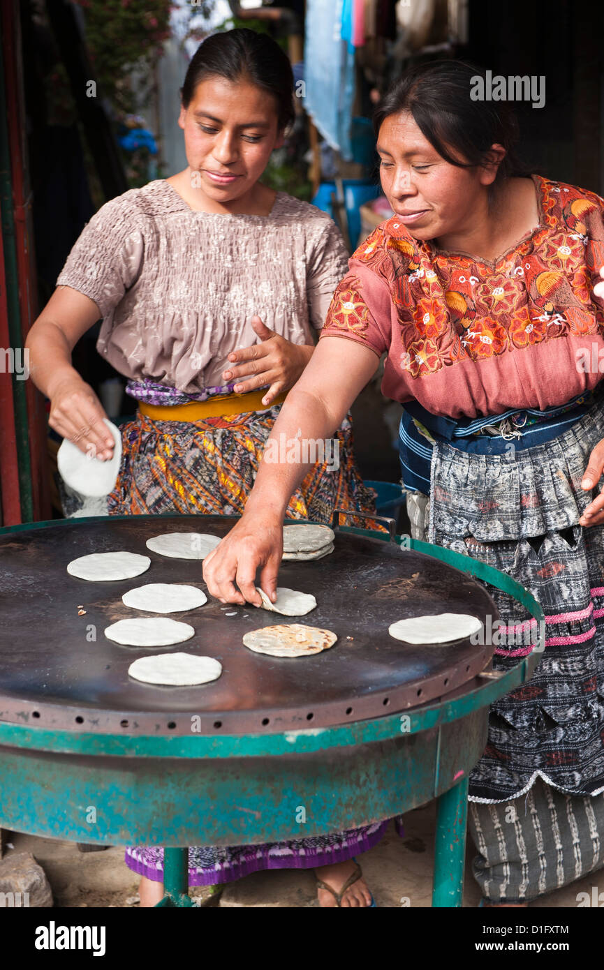 Maya-Frauen Backen Tortillas auf dem Markt von Santiago Sacatepequez, Guatemala, Mittelamerika Stockfoto