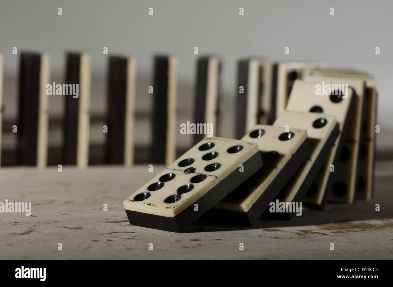 Reihen von aufgereiht altes Elfenbein und Ebenholz Bronze angehefteten stehende Domino blockiert Stücke auf weißem Tan Travertin-Marmor Stockfoto