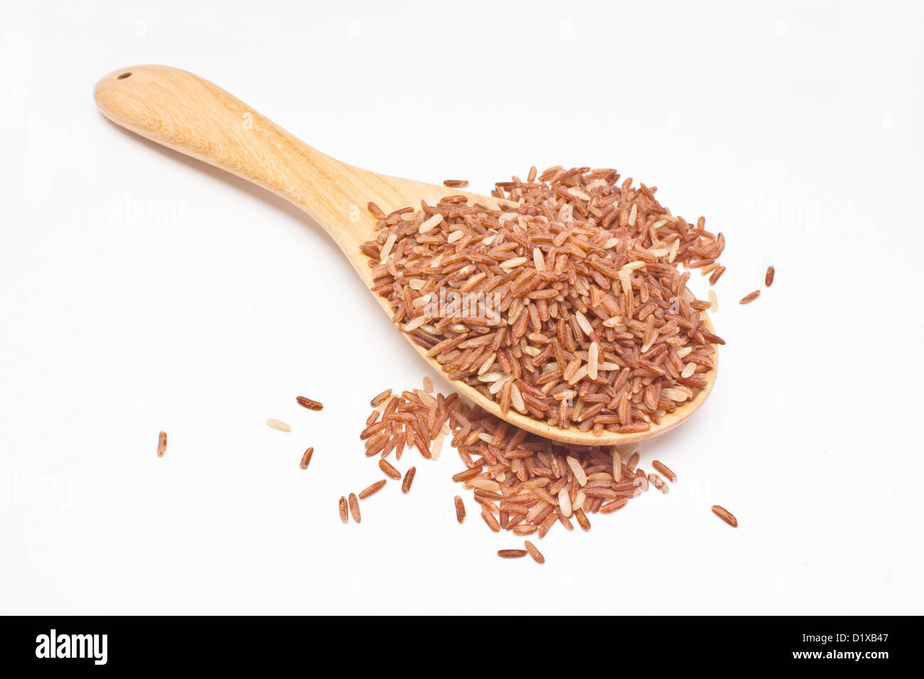 Brauner Reis mit Holzlöffel isoliert auf weißem Hintergrund. Stockfoto