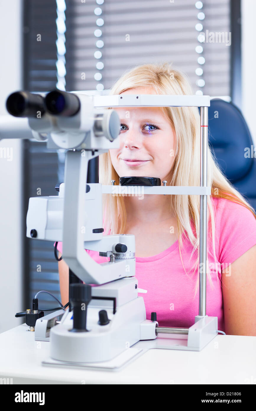 Konzept der Optometrie hübsche, junge Patientin, die ihre Augen vom