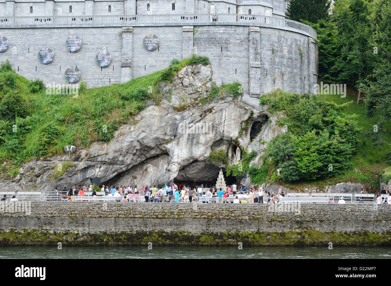 Gläubige und Touristen in der Nähe der Grotte von Lourdes Stockfoto