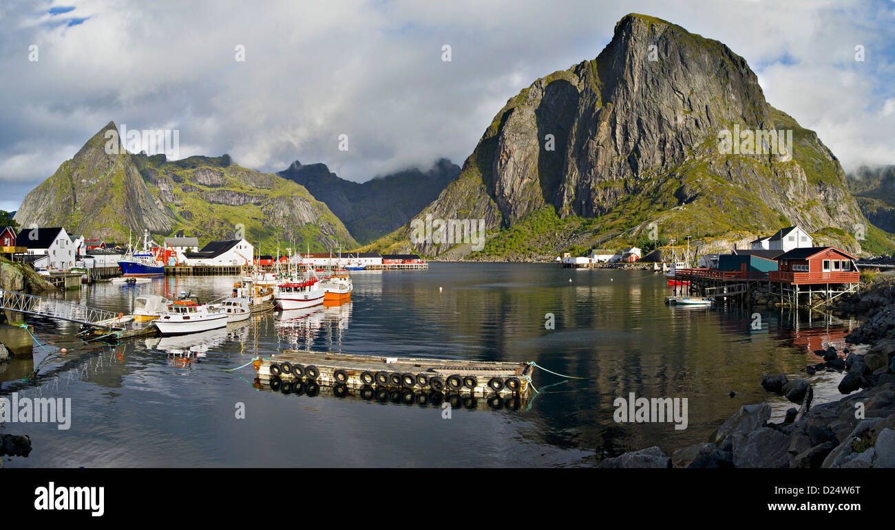 Boote, Kabinen und Liegeplätze am Hamnoy unter den Gipfeln des OLstinden und Festhellstinden, Lofoten, arktische Norwegen Stockfoto