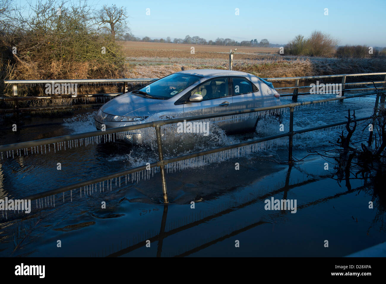 Buttsbury waschen ist eine kleine Furt, die vor kurzem beim Hochwasser unpassierbar gewesen ist, aber es ist wieder auf normales Niveau. Da die Autos passieren ist das Spritzwasser zu Eiszapfen über die Hindernisse für die Seite geworden. heute Morgen lag bei minus 7 C.  Bildnachweis: Allsorts Stock Foto / Alamy Live News Stockfoto