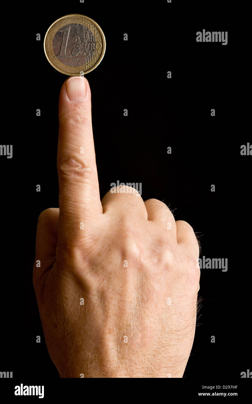Ausgleich einer EURO-Münze an die fing Stockfoto