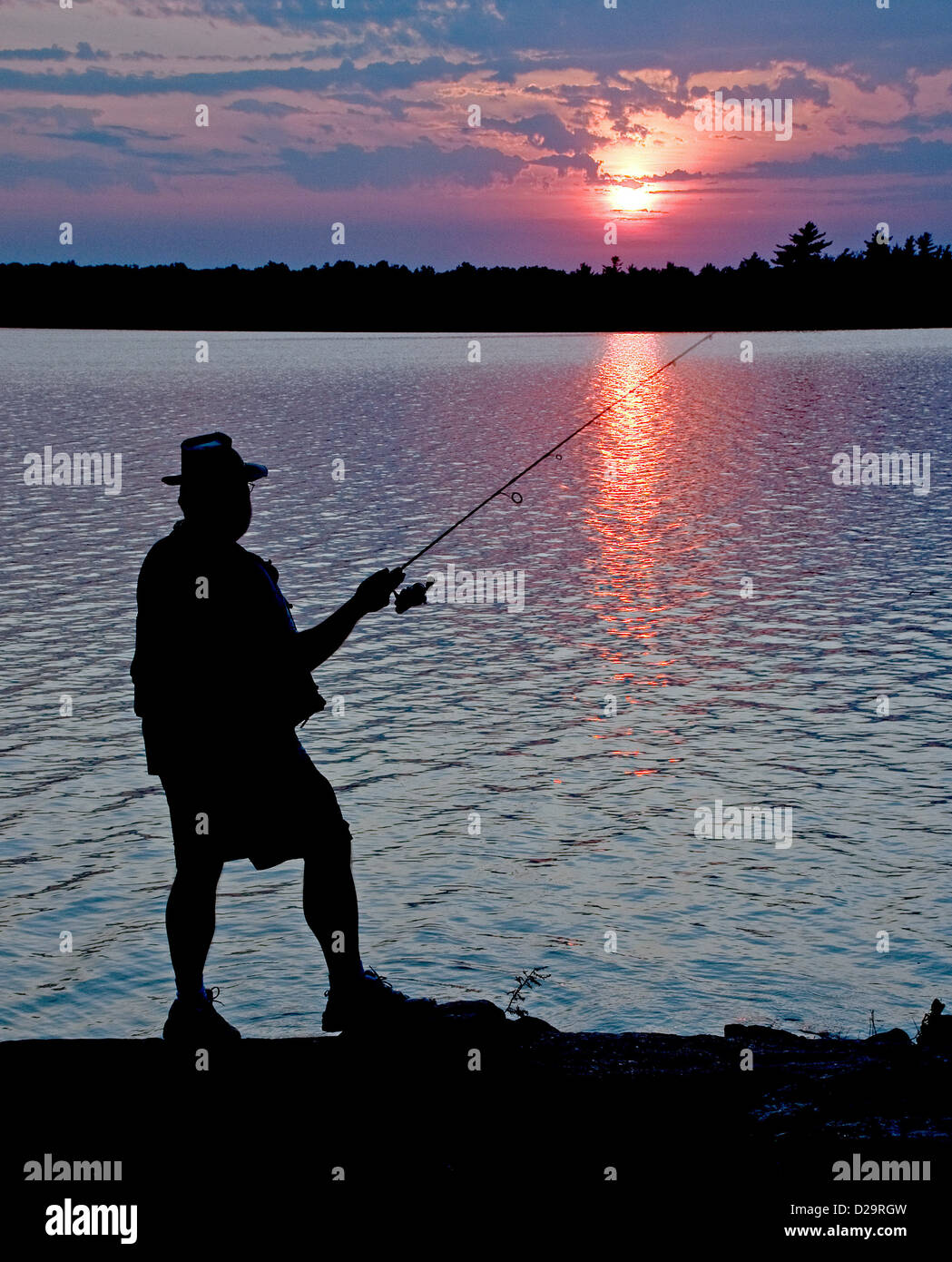 Fischers Silhouette, Sonnenuntergang Stockfoto