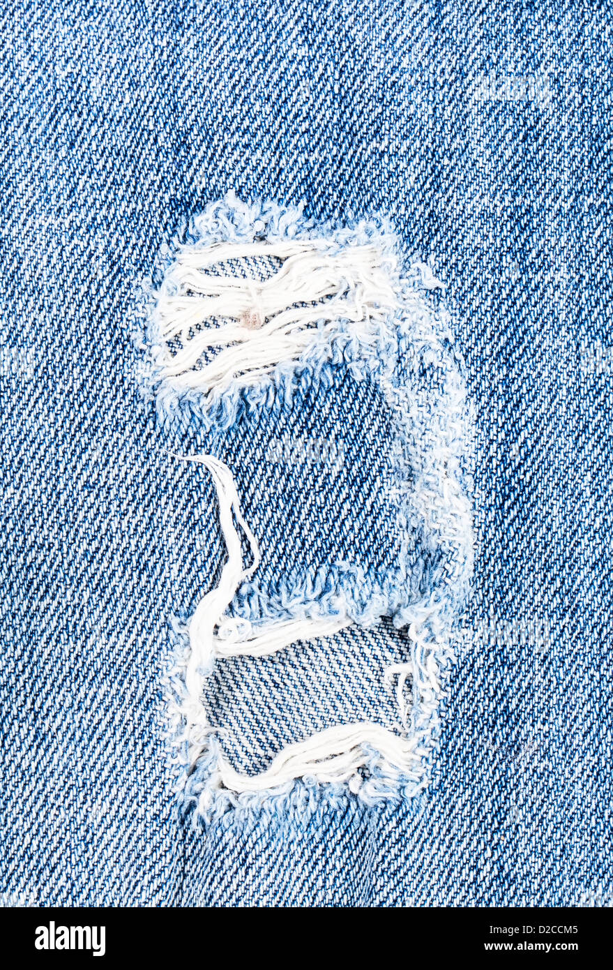 Schönes Loch in Jeans Textil Stockfoto