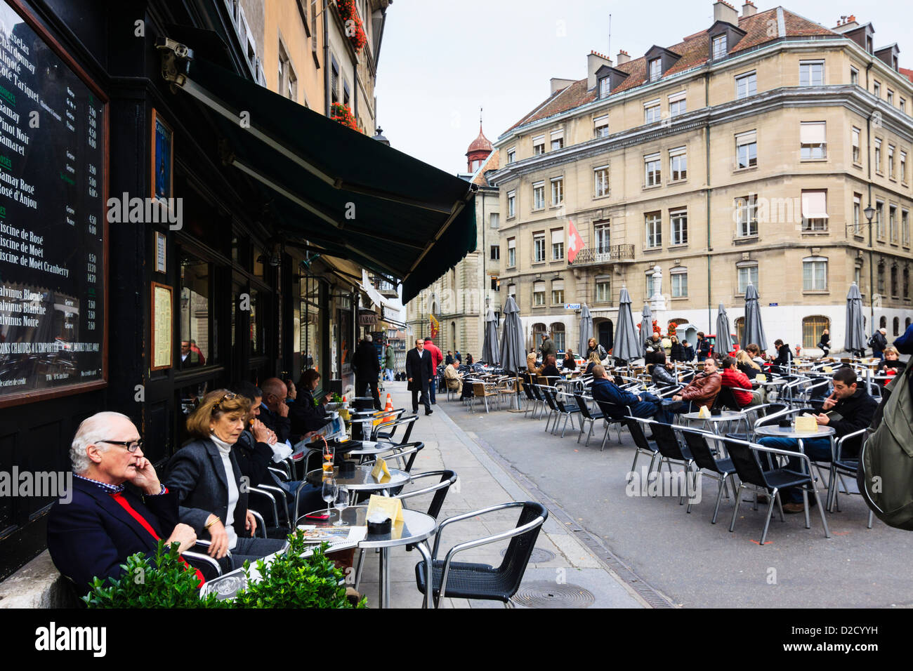 Menschen sitzen in einem der Terrassencafés des Place du Bourg-de-Four, älteste Platz Genfs. Vieille Ville, Genf, Schweiz Stockfoto