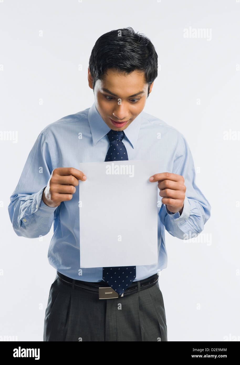 Geschäftsmann, zeigt ein Blatt weißes Papier Stockfoto