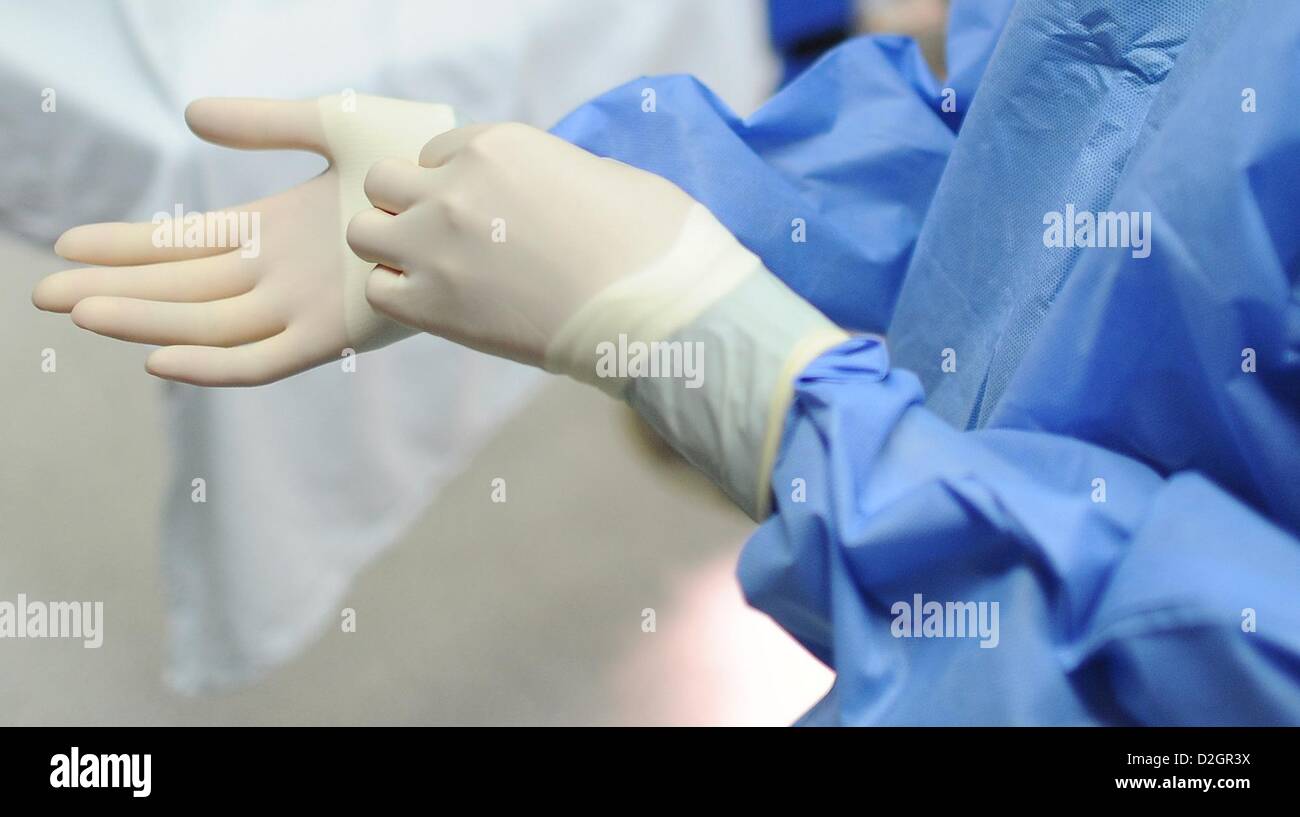 Eine OP-Schwester setzt auf Handschuhe vor ihrer Arbeit beginnen im OP-Saal der Diakonie Klinikum Hamburg (Clinical Center in Hamburg), Deutschland, 10. Januar 2013. Foto: Angelika Warmuth Stockfoto