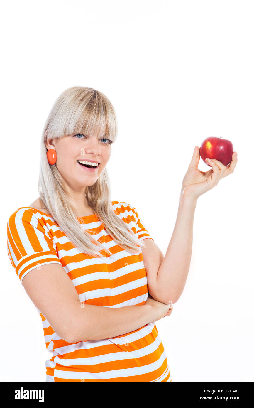 Schöne blonde Mädchen hält einen Apfel isoliert auf weißem Hintergrund Stockfoto