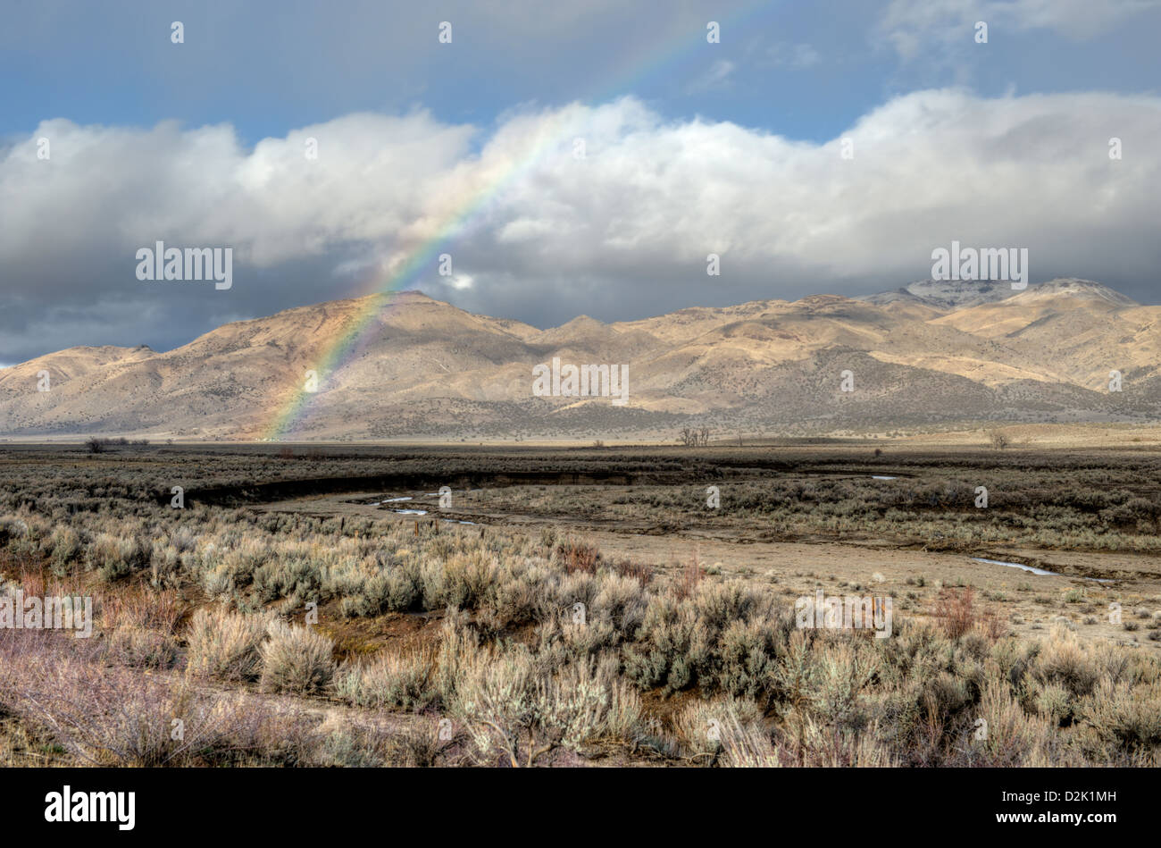 Ein Regenbogen über Long Valley, Kalifornien in der Nähe von Doyle. Die Fort-Salbei-Berge sind in der Ferne. Stockfoto