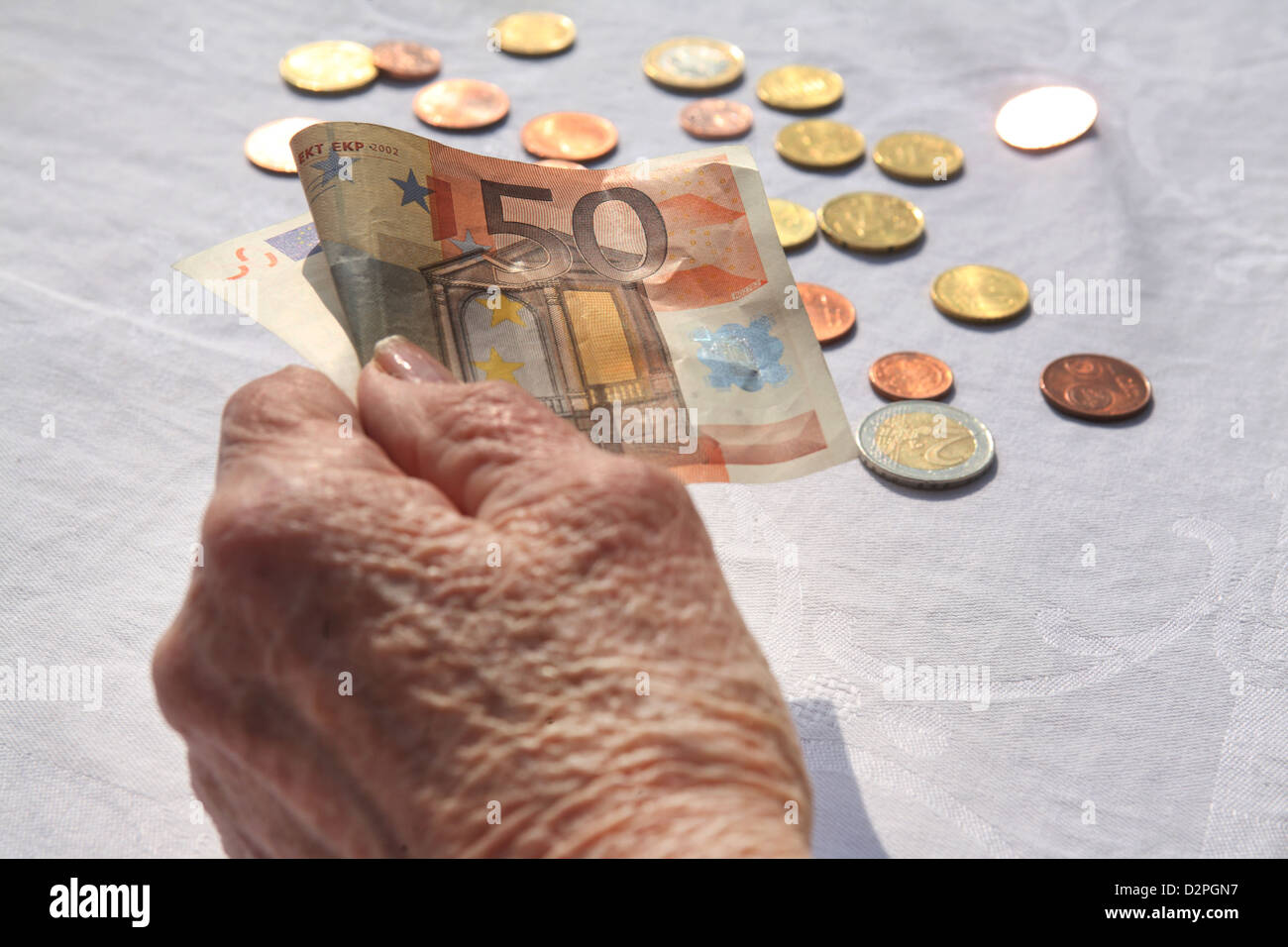 Berlin, Deutschland, die Hand eines Rentners mit ein-Euro-Schein und Münzen Stockfoto