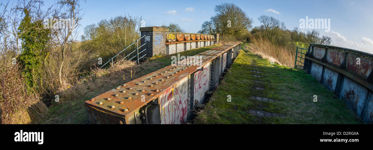 Gusseiserne Brücke tragen Fußweg entlang der alten Eisenbahnlinie im Winter, Warwickshire, England, UK Stockfoto
