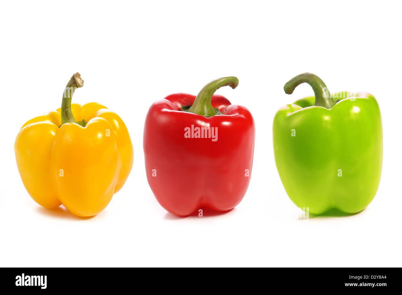 Drei süße Paprika in gelb, rot und grün Farbe in weiß Stockfoto