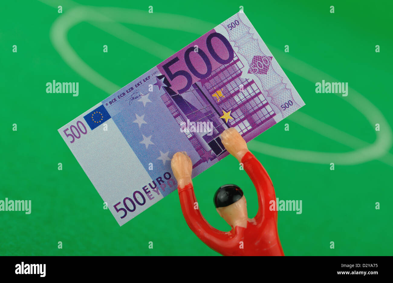 (DATEI - ILLUSTRATION) Archiv zur Veranschaulichung vom 2. Dezember 2009 zeigt eine Tipp-Kick-Figur mit Spielgeld in Form von einem 500-Euro-Schein in Frankfurt Main, Deutschland. Foto: Uwe Anspach Stockfoto