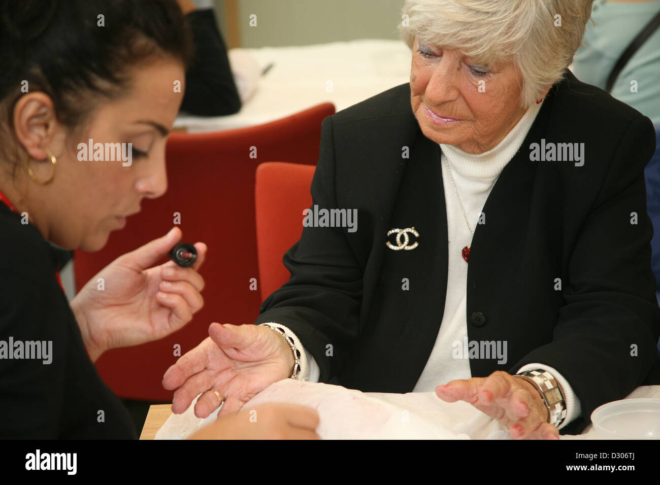 Senioren genießen Nagel Maniküre im Gemeindezentrum Stockfoto