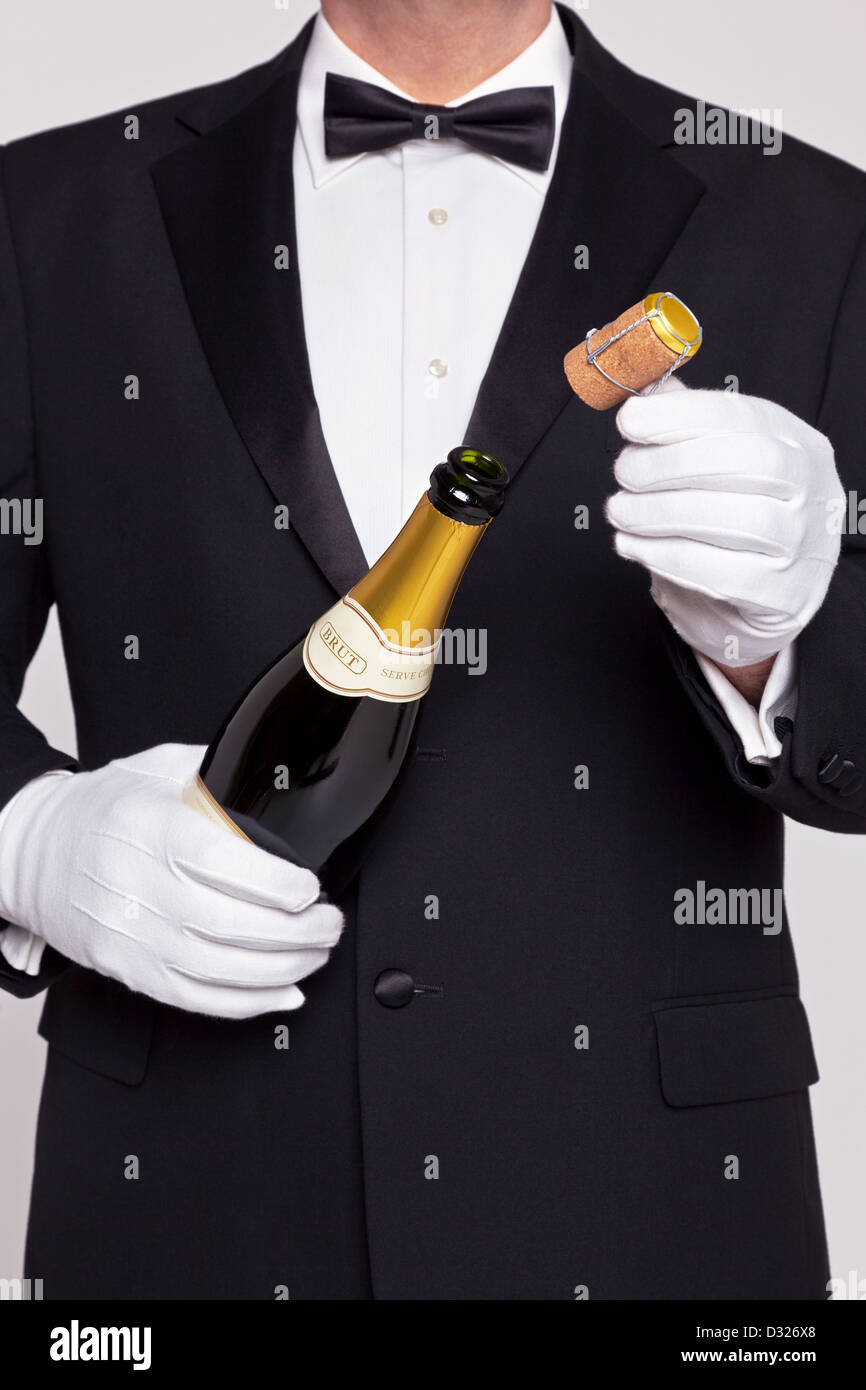 Kellner eine Flasche Champagner, den Korken in der anderen Hand öffnen. Stockfoto