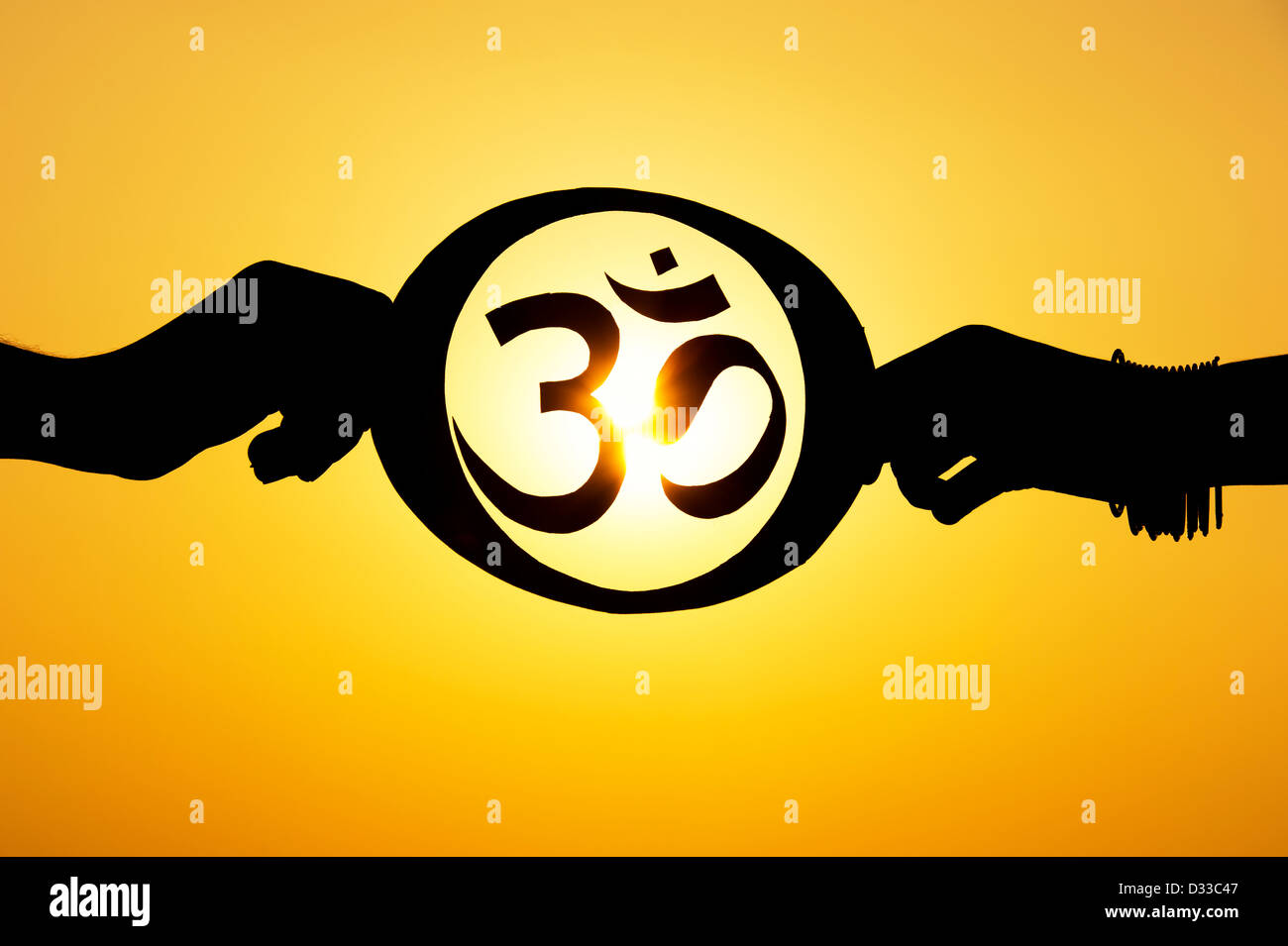 Hände halten hinduistischen OM / AUM symbol bei Sonnenuntergang. Indien. Silhouette Stockfoto