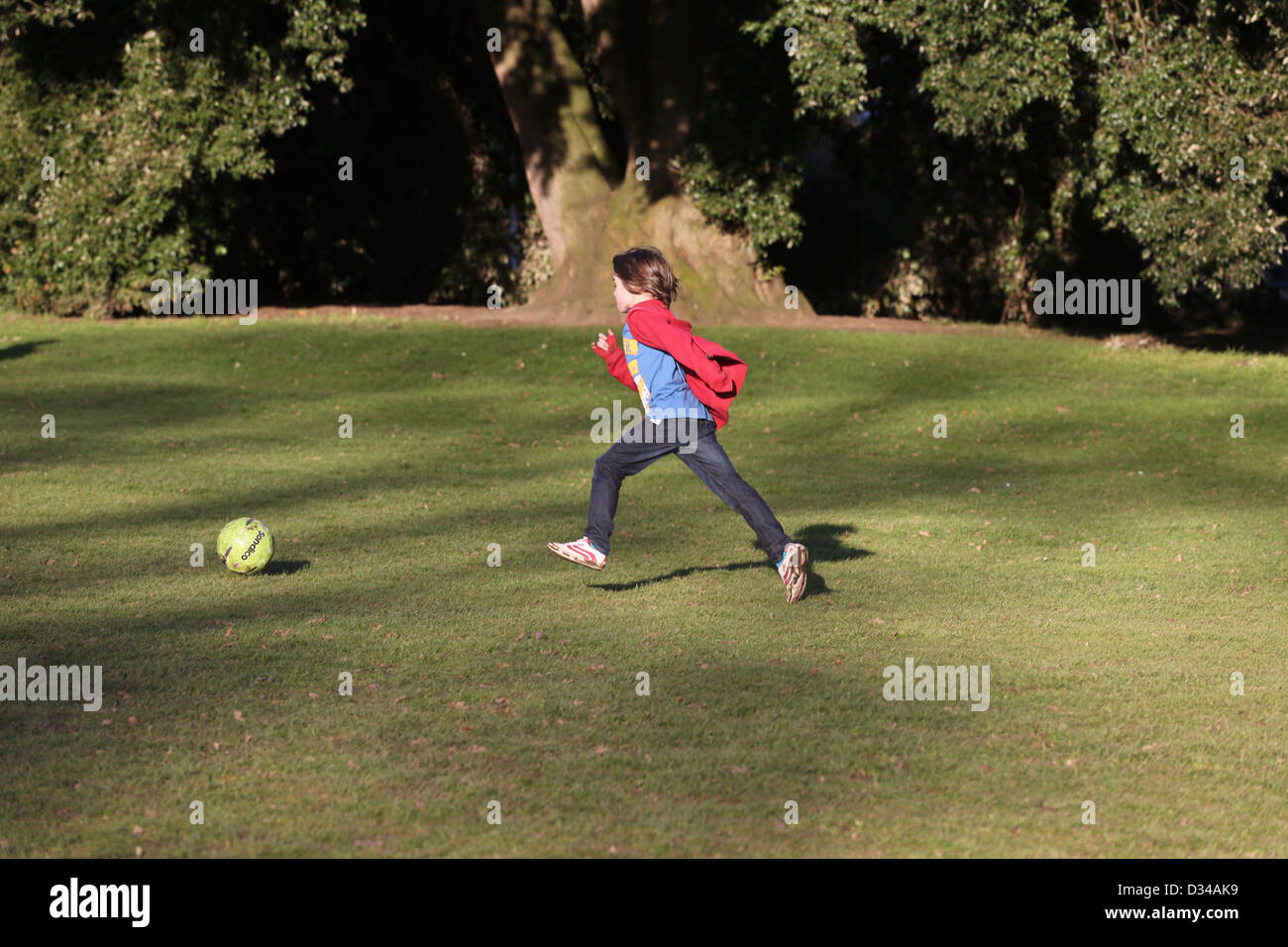 Jungen Fußball spielen, an der die Pittville Pumpe Raum Lustgärten Cheltenham Gloucestershire in England Stockfoto