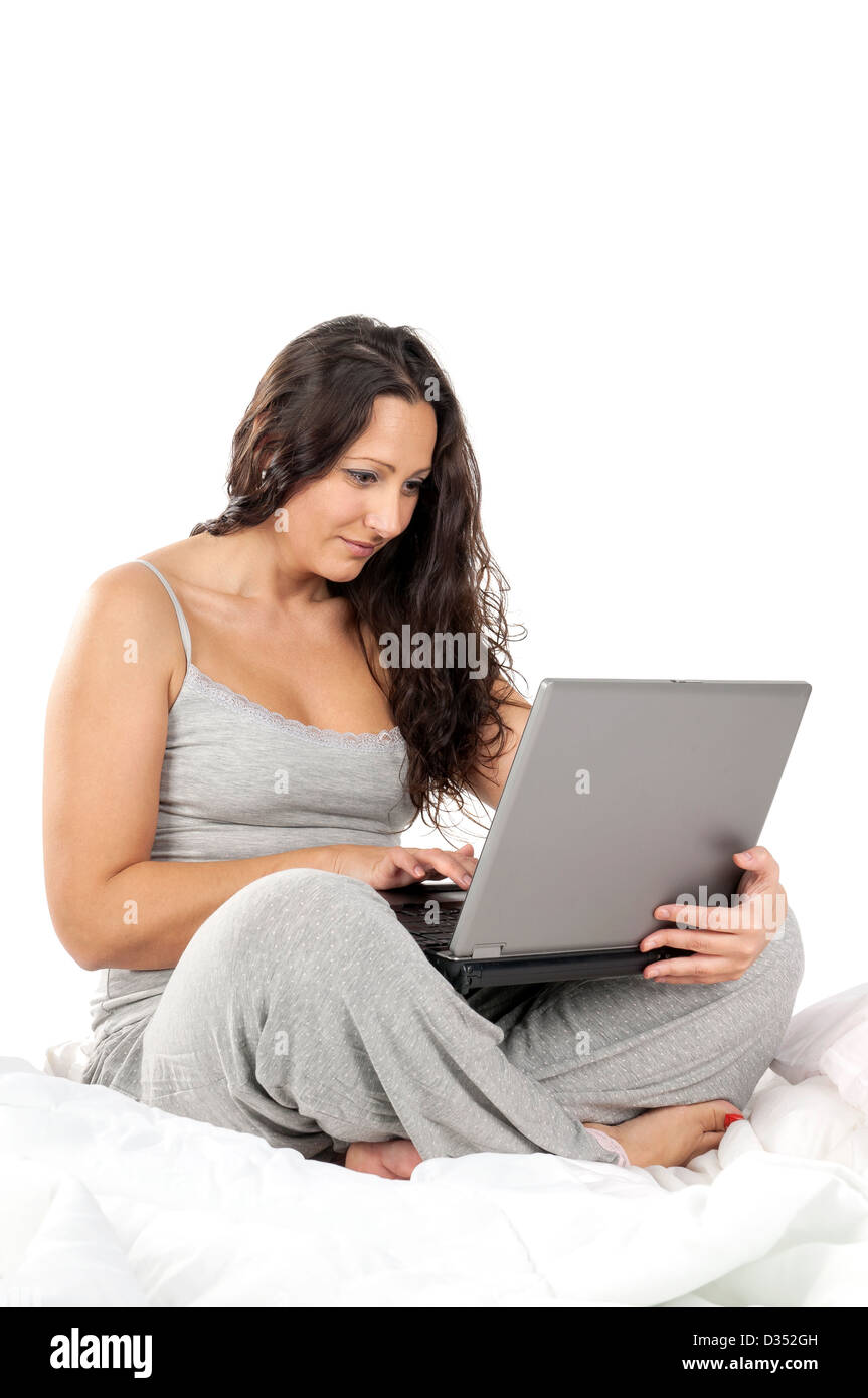 Schöne Frau im Bett mit laptop Stockfoto