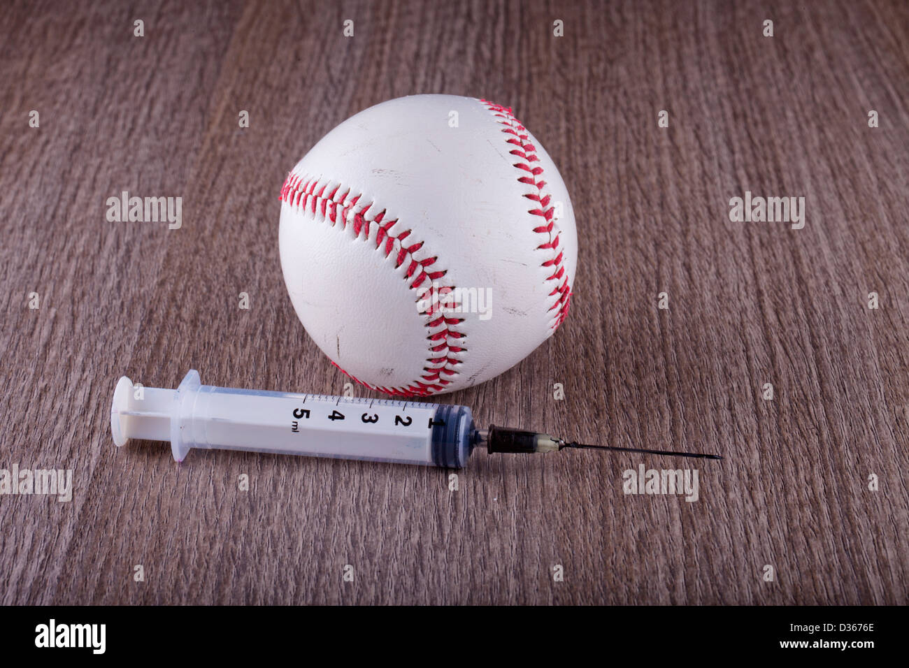 Ein Baseball in der Nähe einer Spritze über hölzerne Hintergrund Stockfoto