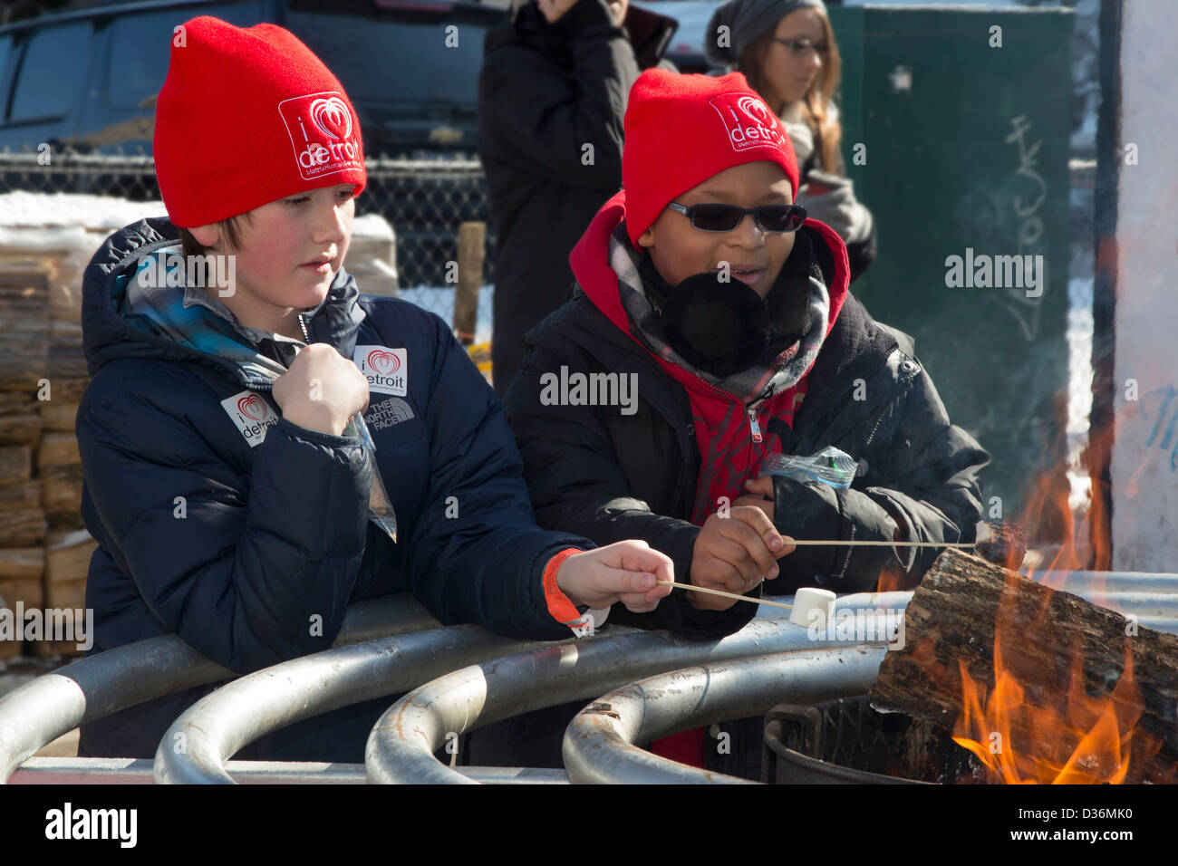 Jungen toast Marshmallows über dem Feuer im Campus Martius Park in Detroit Winter Blast Festival. Stockfoto