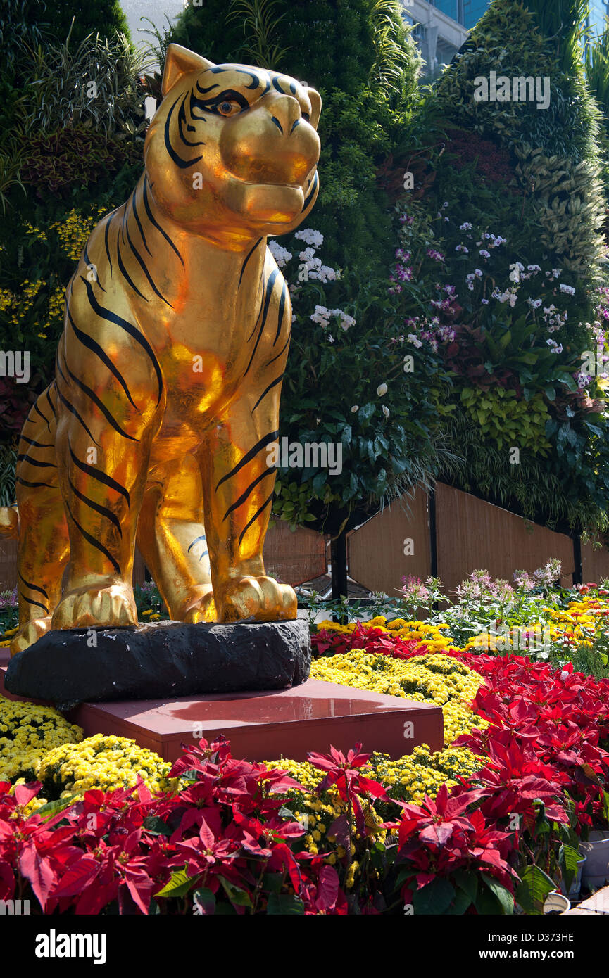 Golden Tiger-Statue, umgeben von Blumen in der Blumenpark Anzeige während der Tet in Saigon Vietnam Stockfoto