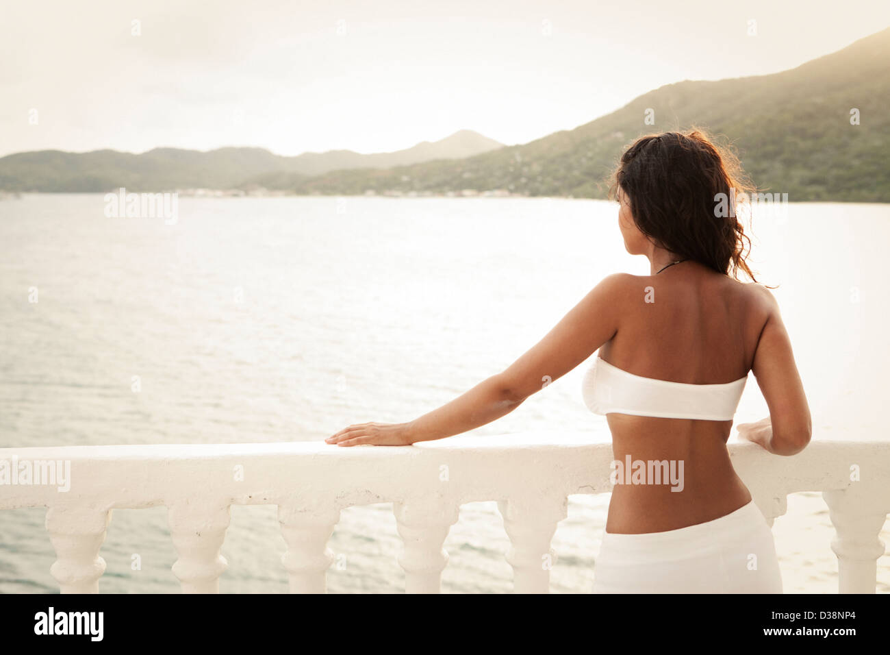 Frau trägt Bikini auf Balkon Stockfoto