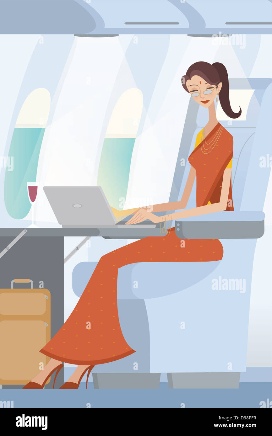 Geschäftsfrau, die Arbeiten auf einem Laptop in einem Flugzeug Stockfoto