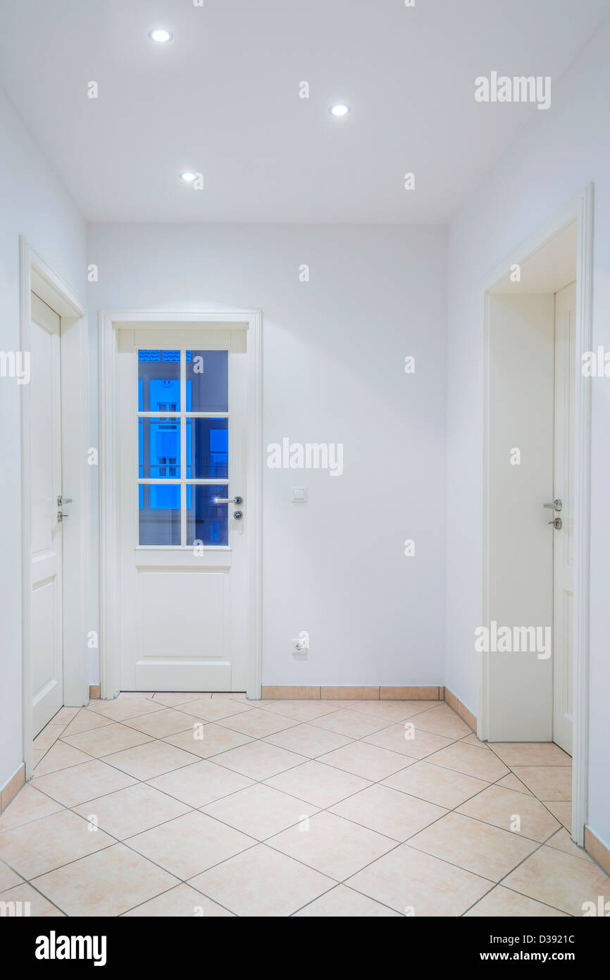 Indoor Foyer mit weißen Türen, hellbraun geflieste Boden, Lampen Stockfoto