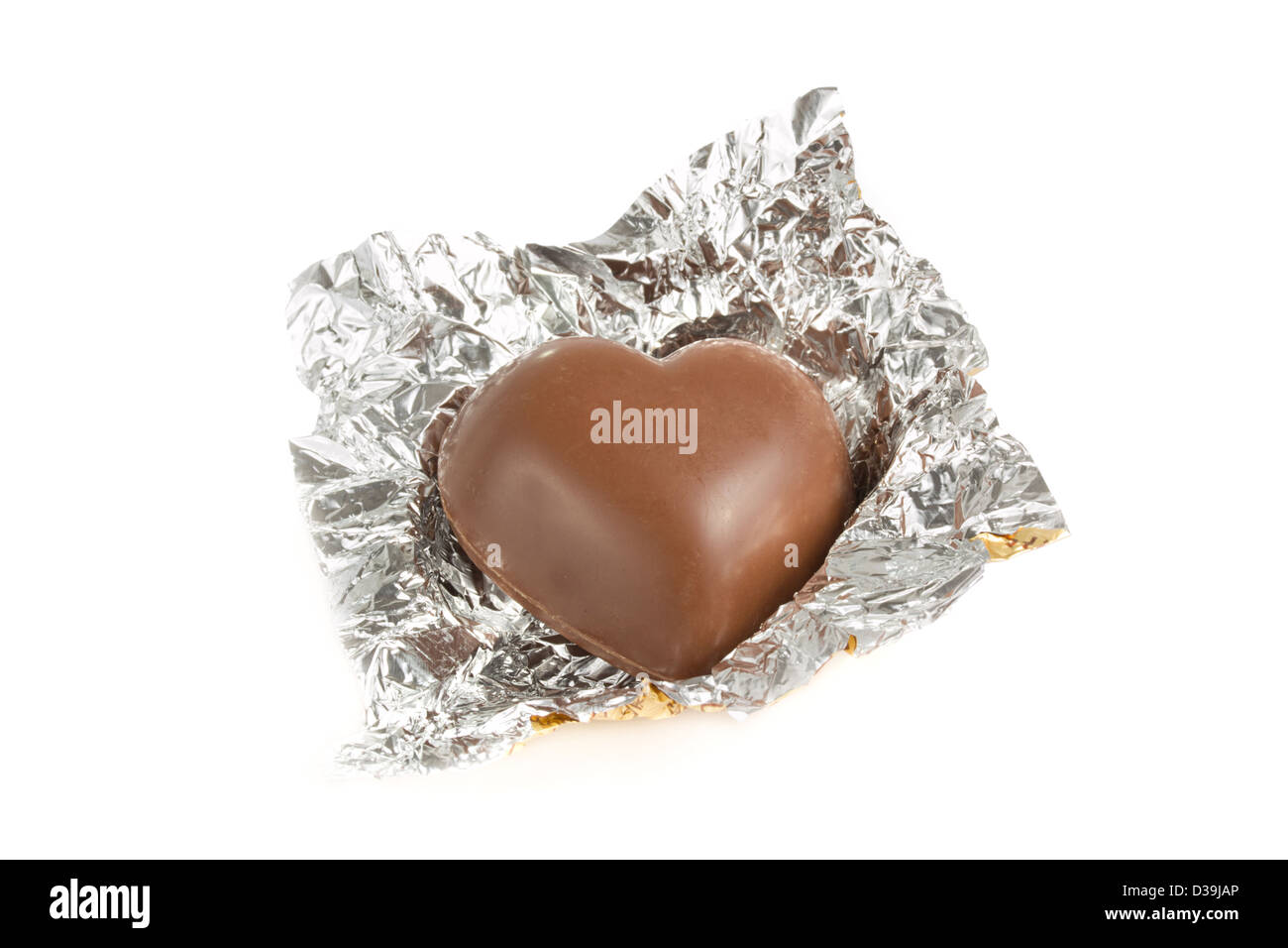 Schokolade in eine Goldfolie Wrapper in Herzform Stockfoto