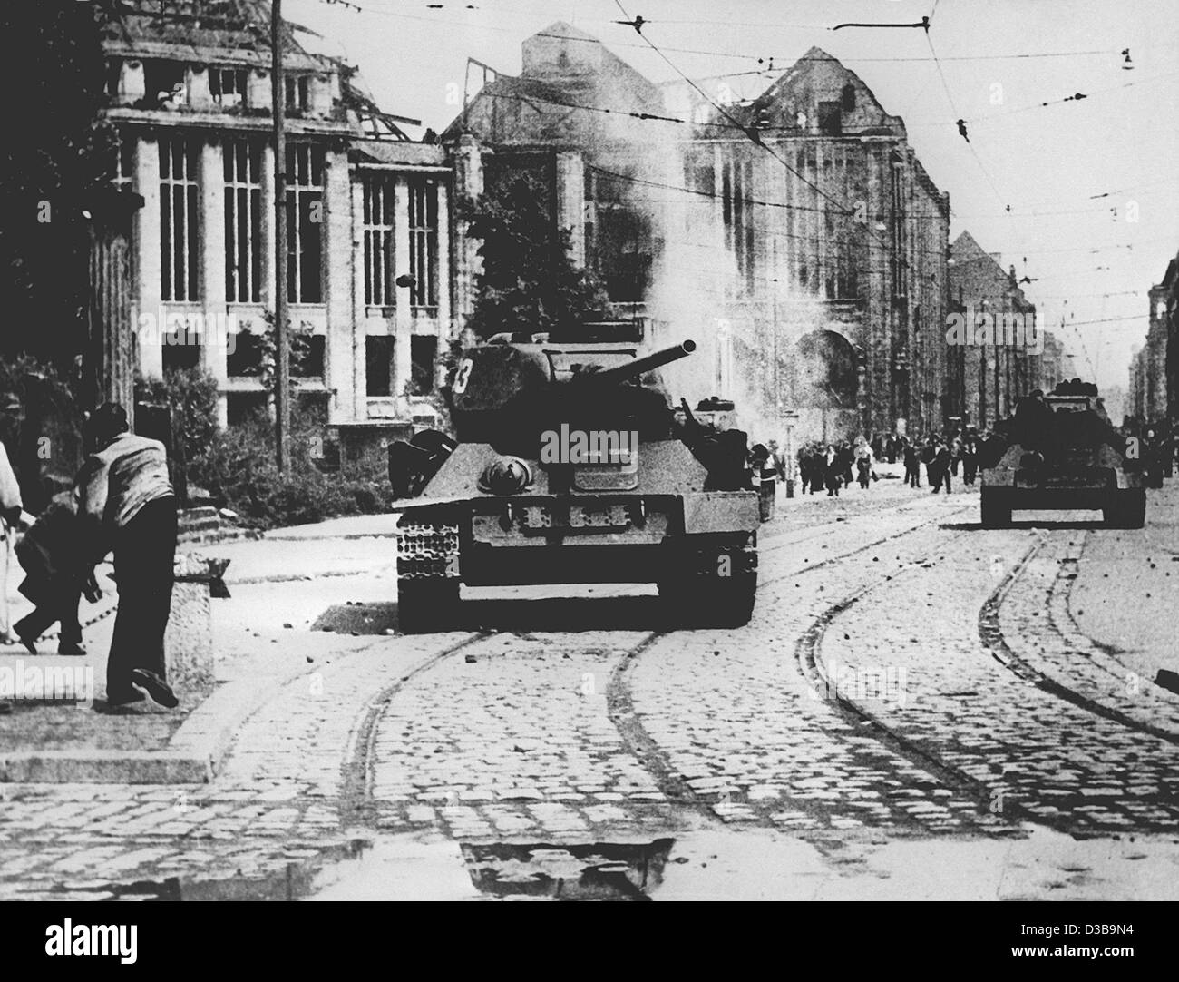 (Dpa-Dateien) - Demonstranten werfen Steinen auf sowjetische Panzer während der Aufstände gegen das kommunistische Regime in Ost-Berlin, 17. Juni 1953. Der Aufstand eskalierte bei Streiks und einer Demonstration gegen unzumutbare Produktionsquoten durch sowjetische Panzer und Truppen am 17. Juni abgerissen wurden. Stockfoto