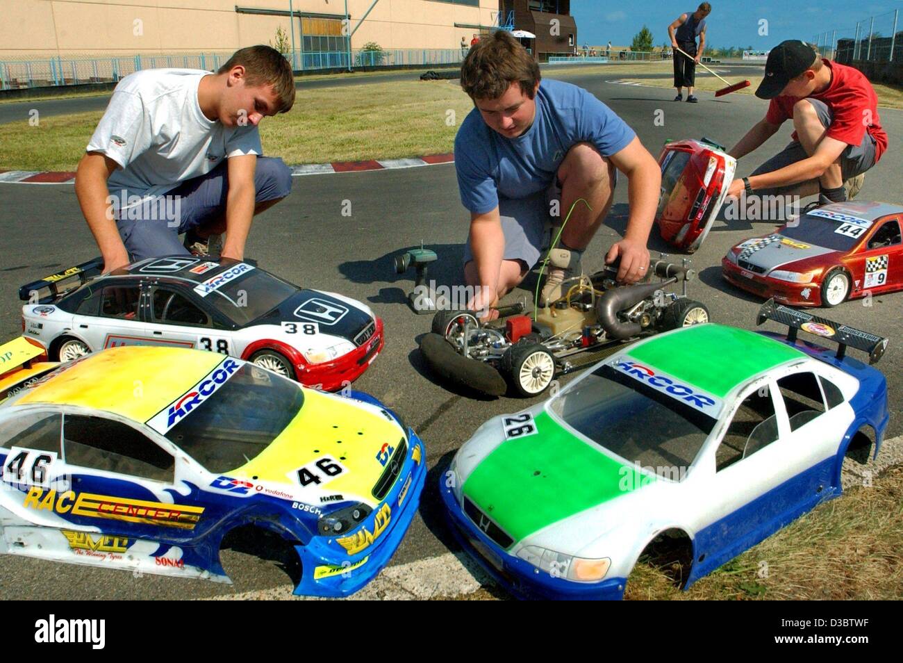 (Dpa) - die Newcomer Robert Walther, Daniel Böhm und Falko Ketter (v.l) bereiten ihre Modellautos Toruing für die deutschen Meisterschaften der Modellautos in Muehlau, Deutschland, 16. August 2003. 72 Teilnehmer nahmen mit ihren Autos 5 PS, die Höchstgeschwindigkeit von 80 km/h erreichen können. Stockfoto