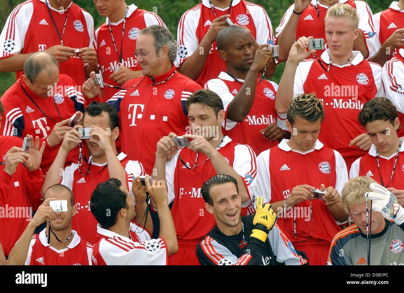 (Dpa) - posieren die Spieler der deutschen Fußball-Meister FC Bayern München mit Kameras von einem Sponsor während ein Fotoshooting in ihr Heimstadion in München, 24. Juli 2003. Stockfoto